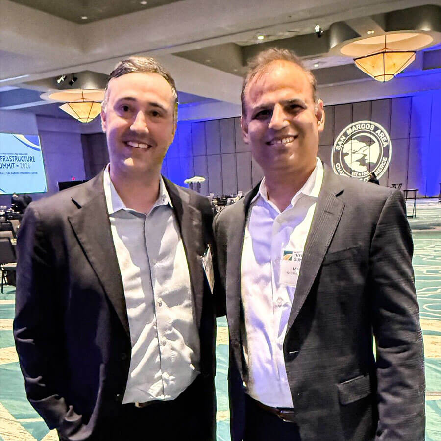 Two attendees posing together at the San Marcos Area Chamber of Commerce Infrastructure Summit 2026.